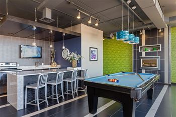 a games room with a pool table and a bar